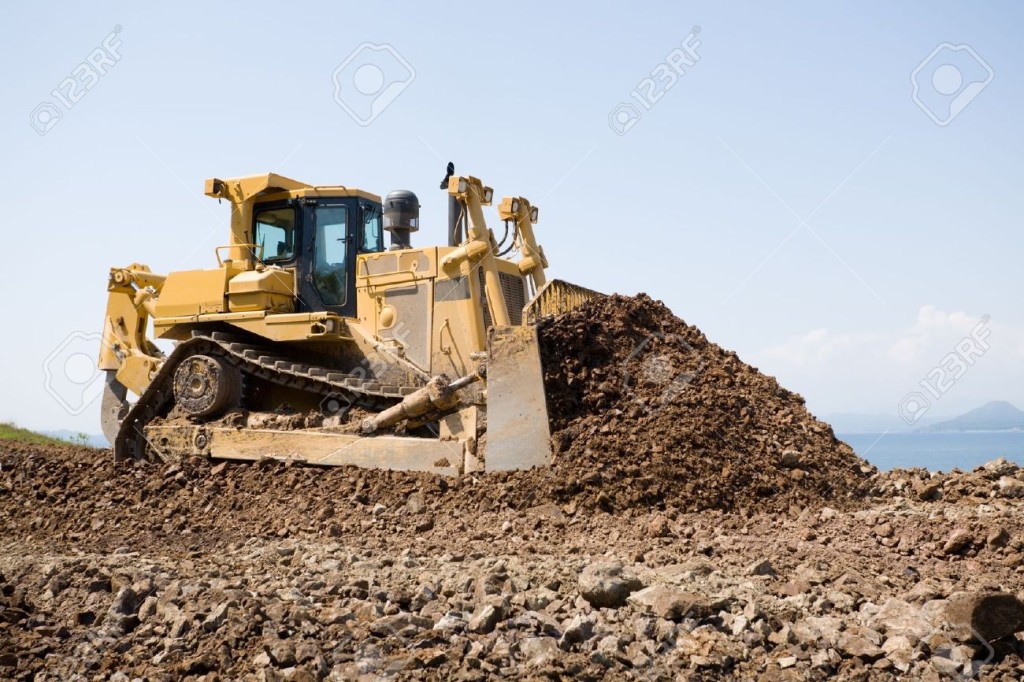 10517924-The-bulldozer-on-a-building-site-On-a-background-the-sea--Stock-Photo